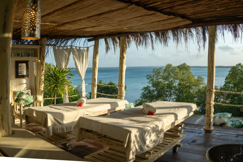 The full width of the Jua Spa deck, curtains drawn back to the creek