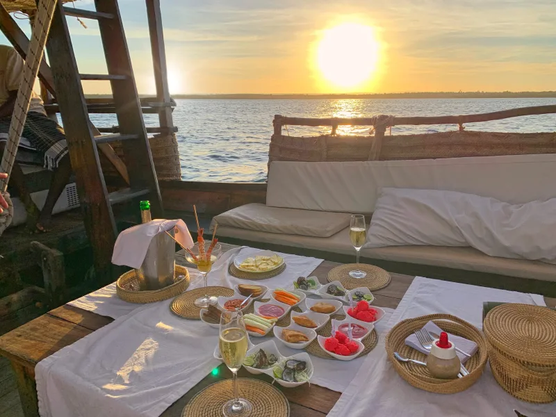 The table set on deck for the sunset aperitivo as the sun drops towards the horizon