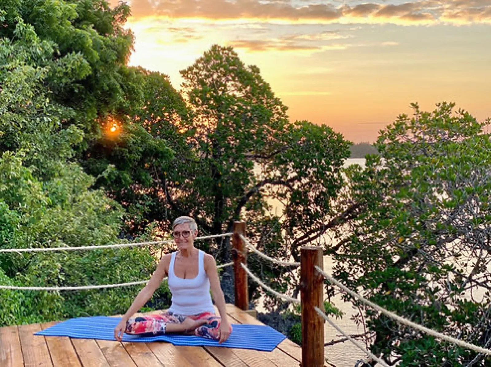 Net loungers under a thatched deck with an ocean view, a space for yoga and relaxation